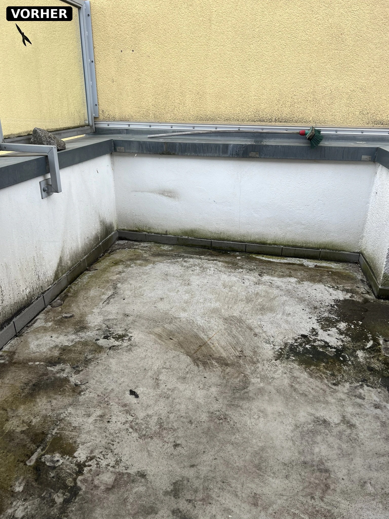 Stark verschmutzter Balkonboden mit Moos und Algen vor der Reinigung